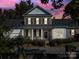 Evening view of two-story house with brick facade at 1017 N Sharon Amity Rd, Charlotte, NC 28211