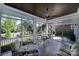 Relaxing screened porch with seating and ceiling fan at 1017 N Sharon Amity Rd, Charlotte, NC 28211