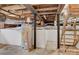 Unfinished basement with water heater and wooden stairs at 103 2Nd Nw Ave, Hickory, NC 28601