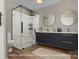 Sleek bathroom featuring marble walk-in shower, double vanity with gold fixtures, and modern design at 103 2Nd Nw Ave, Hickory, NC 28601