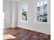 Well-lit bedroom featuring hardwood floors and multiple windows at 103 2Nd Nw Ave, Hickory, NC 28601