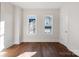 Well-lit bedroom featuring hardwood floors and two windows at 103 2Nd Nw Ave, Hickory, NC 28601