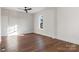 Spacious bedroom with hardwood floors, ceiling fan, and wainscoting at 103 2Nd Nw Ave, Hickory, NC 28601