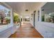 Inviting front porch with wooden flooring and white columns at 103 2Nd Nw Ave, Hickory, NC 28601