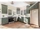 Renovated kitchen boasts green cabinets, marble countertops, and stainless steel appliances at 103 2Nd Nw Ave, Hickory, NC 28601