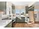 Modern kitchen featuring green cabinets, marble countertops, and gold fixtures at 103 2Nd Nw Ave, Hickory, NC 28601