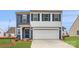 Two-story house with blue siding, white trim, and a two-car garage at 165 Smokey Way, Statesville, NC 28625