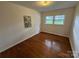 This bedroom has hardwood floors and a double window with views to the outside at 1727 Hartford Dr, Gastonia, NC 28052