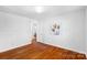 Well-lit bedroom with hardwood floors, neutral decor, and ample space at 1727 Hartford Dr, Gastonia, NC 28052