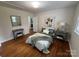 Bright bedroom featuring hardwood floors, stylish decor, and natural light at 1727 Hartford Dr, Gastonia, NC 28052