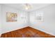 Bright bedroom with hardwood floors, base trim, two windows, and a ceiling fan at 1727 Hartford Dr, Gastonia, NC 28052