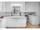 White kitchen with light countertops and laundry hookups at 1727 Hartford Dr, Gastonia, NC 28052