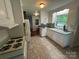 Charming kitchen with white cabinets, vintage-style appliances, and natural light from the window at 1727 Hartford Dr, Gastonia, NC 28052