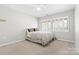 Bedroom with window, ceiling fan, and neutral walls at 423 Whitestone Rd, Charlotte, NC 28270