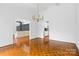 Bright dining room features hardwood floors and a chandelier at 423 Whitestone Rd, Charlotte, NC 28270