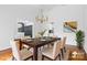 Virtually staged dining room with hardwood floors, chandelier, and modern table setting at 423 Whitestone Rd, Charlotte, NC 28270