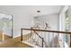 Upstairs hallway with tile floors and wooden railing at 423 Whitestone Rd, Charlotte, NC 28270