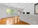 Living room with hardwood floors and white brick fireplace at 423 Whitestone Rd, Charlotte, NC 28270