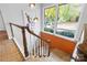 View of a staircase with wood railing and brick accent wall at 423 Whitestone Rd, Charlotte, NC 28270