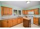 Functional kitchen featuring wood cabinetry, white appliances, and light countertops, perfect for cooking at 802 E Harrison Ave, Gastonia, NC 28054