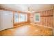 Inviting living room featuring unique wood-paneled walls and ample natural light from multiple windows at 802 E Harrison Ave, Gastonia, NC 28054