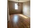 Empty dining room with hardwood floors, a chandelier and one large window at 8540 Indian Summer Trl, Harrisburg, NC 28075