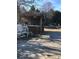 Covered outdoor bar with a wooden deck and several white Adirondack chairs at 8540 Indian Summer Trl, Harrisburg, NC 28075