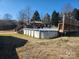 An above ground backyard pool featuring an access ladder, and a surrounding yard at 8540 Indian Summer Trl, Harrisburg, NC 28075