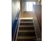 Carpeted staircase with wooden handrails leading to the upper level at 8540 Indian Summer Trl, Harrisburg, NC 28075