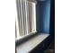 Built-in window seat with blue walls and window coverings at 8540 Indian Summer Trl, Harrisburg, NC 28075