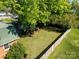 Aerial view of spacious backyard with mature trees, and lush green lawn at 1018 Carysbrook Ln, Charlotte, NC 28217