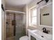 Updated bathroom with new vanity, fixtures, shower and tiled shower with glass door at 1018 Carysbrook Ln, Charlotte, NC 28217