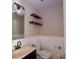 Cozy half-bathroom featuring a vanity and decorative shelves at 1018 Carysbrook Ln, Charlotte, NC 28217