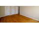 Bedroom featuring wood flooring, a fresh coat of paint, and multiple closets at 1018 Carysbrook Ln, Charlotte, NC 28217