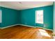 Bedroom showcases bright paint, hardwood floors, window, and natural light at 1018 Carysbrook Ln, Charlotte, NC 28217