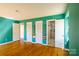 Spacious bedroom featuring hardwood floors, fresh paint, a shower and multiple closets at 1018 Carysbrook Ln, Charlotte, NC 28217