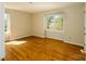 Bright, airy bedroom with hardwood floors and natural light from the large window at 1018 Carysbrook Ln, Charlotte, NC 28217
