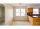 Sunny dining area with tiled floors, a window and an adjacent kitchen at 1018 Carysbrook Ln, Charlotte, NC 28217