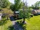 Aerial view of a well-maintained home featuring a green roof, mature trees, and a long driveway at 1018 Carysbrook Ln, Charlotte, NC 28217