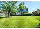 Charming two-story brick home with a lush green lawn and mature shade tree, offering classic curb appeal at 1018 Carysbrook Ln, Charlotte, NC 28217