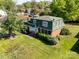 Charming home boasts a well-manicured lawn, mature trees, and a classic brick facade, offering great curb appeal at 1018 Carysbrook Ln, Charlotte, NC 28217