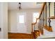 Bright foyer with hardwood floors and decorative staircase, creating a welcoming entry space at 1018 Carysbrook Ln, Charlotte, NC 28217