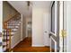 Welcoming foyer with hardwood floors and staircase, providing a warm and inviting entry to the home at 1018 Carysbrook Ln, Charlotte, NC 28217