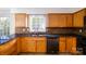 Kitchen featuring oak cabinets, dark countertops, and tiled backsplash, a practical space for cooking at 1018 Carysbrook Ln, Charlotte, NC 28217