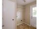 Practical laundry room featuring shelving and access to the exterior at 1018 Carysbrook Ln, Charlotte, NC 28217
