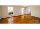 Bright living room with hardwood floors and large windows, perfect for comfortable living at 1018 Carysbrook Ln, Charlotte, NC 28217