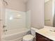 Clean bathroom with a shower-tub combo, white fixtures and complemented by dark wood vanity at 14121 Winford Ln, Charlotte, NC 28262