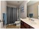 This bathroom features a tub with a shower, modern vanity, and neutral wall color at 14121 Winford Ln, Charlotte, NC 28262