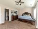 Main bedroom suite features carpet floors, a ceiling fan, and a dresser with an adjoining bathroom at 14121 Winford Ln, Charlotte, NC 28262