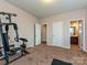 View of workout area in bedroom with carpeted floor, open doorways, and exercise equipment at 14121 Winford Ln, Charlotte, NC 28262